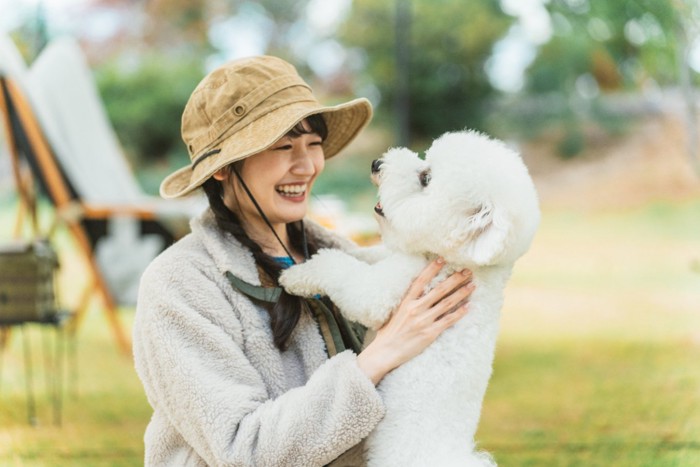 犬を抱き上げる女性