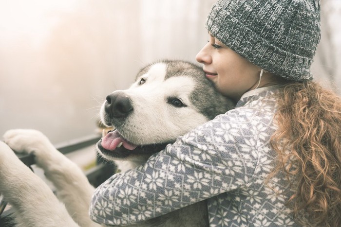 大型犬を抱きしめる女性 